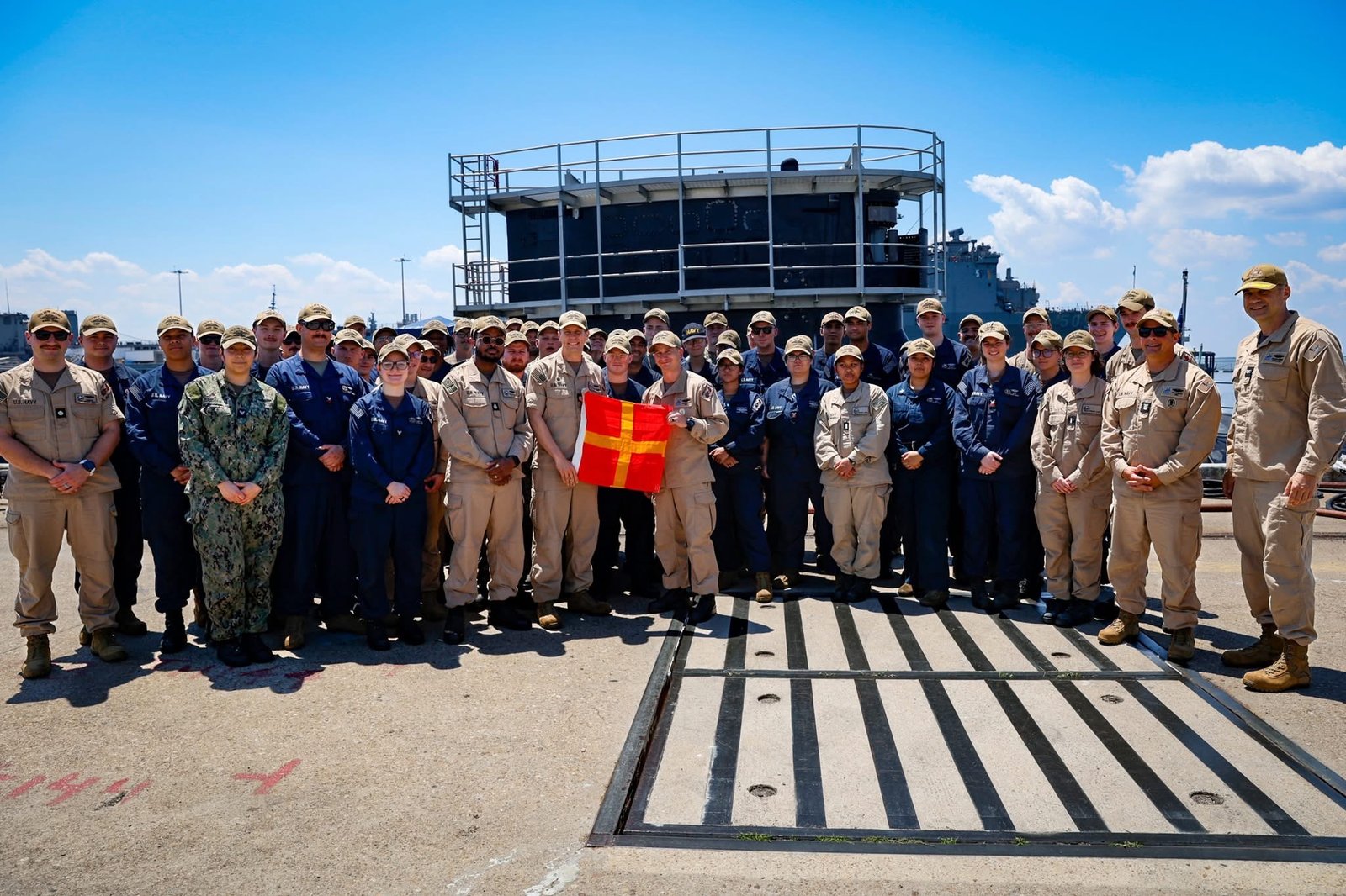 CDR Simmons and the crew of USS New Jersey receive the Combat Ready Romeo Flag from Commodore Jordan.