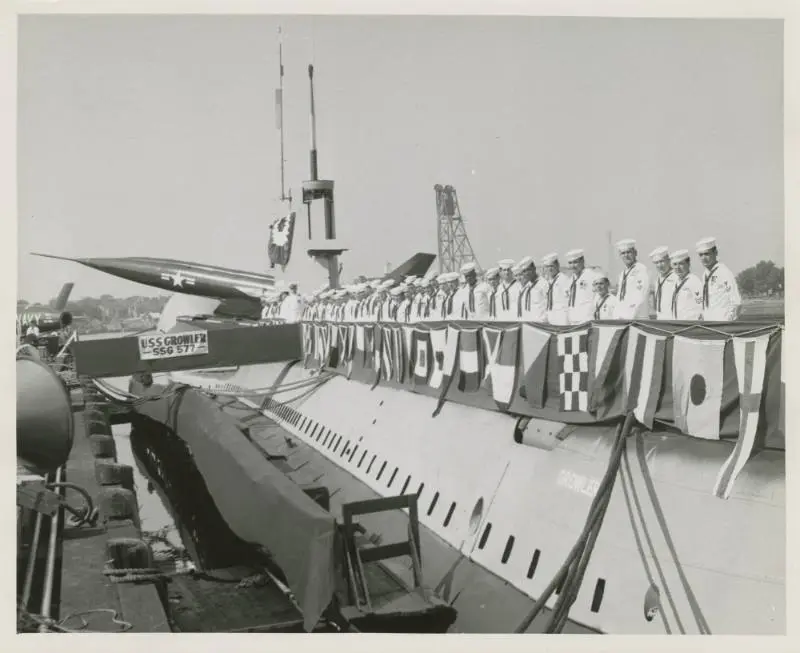 Sailors lined up during the commissioning ceremony for USS Growler with Regulus II missile visible