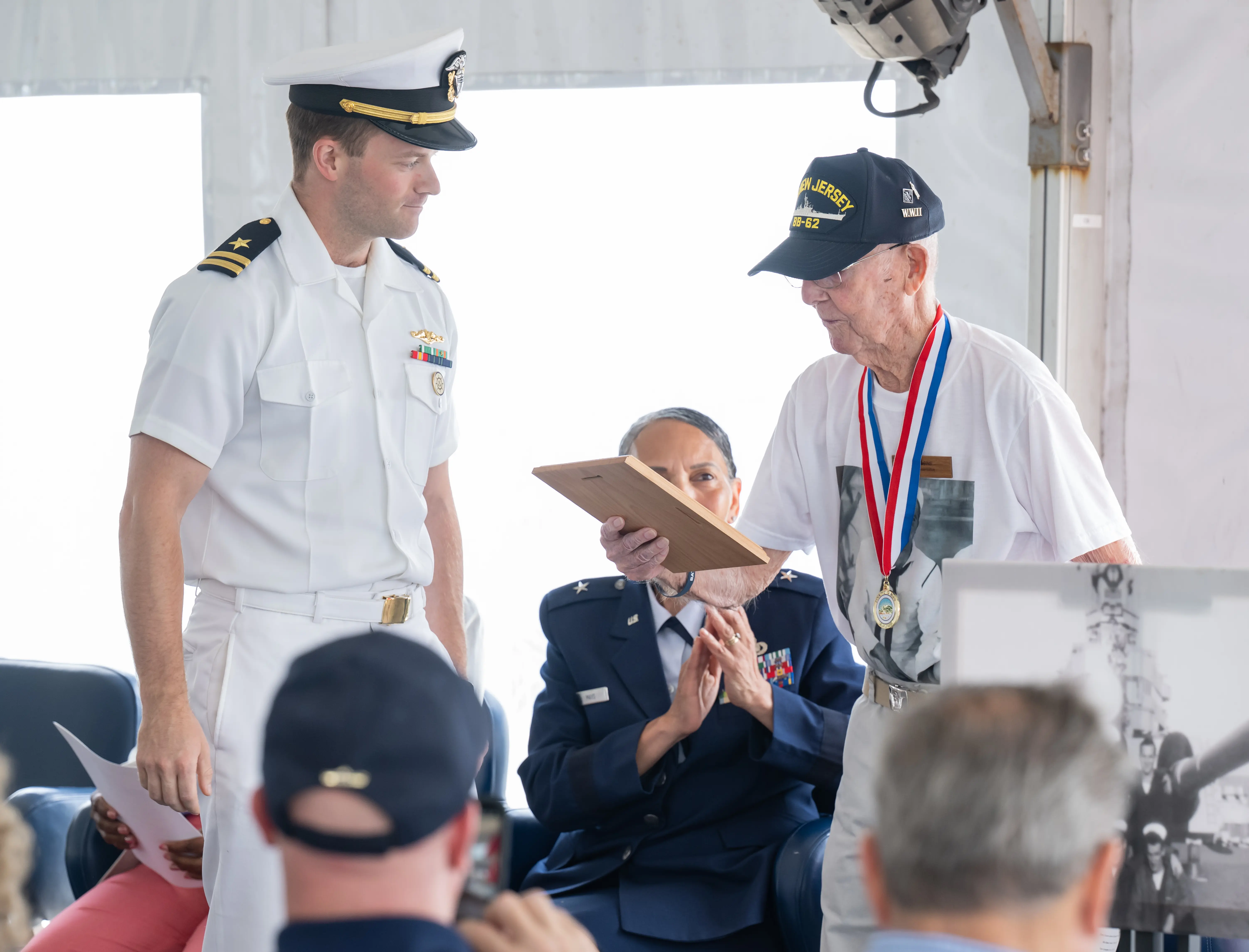 LT Matthew Dods, USN, presents Paul Robbins with an Honorary Plank Owner plaque.